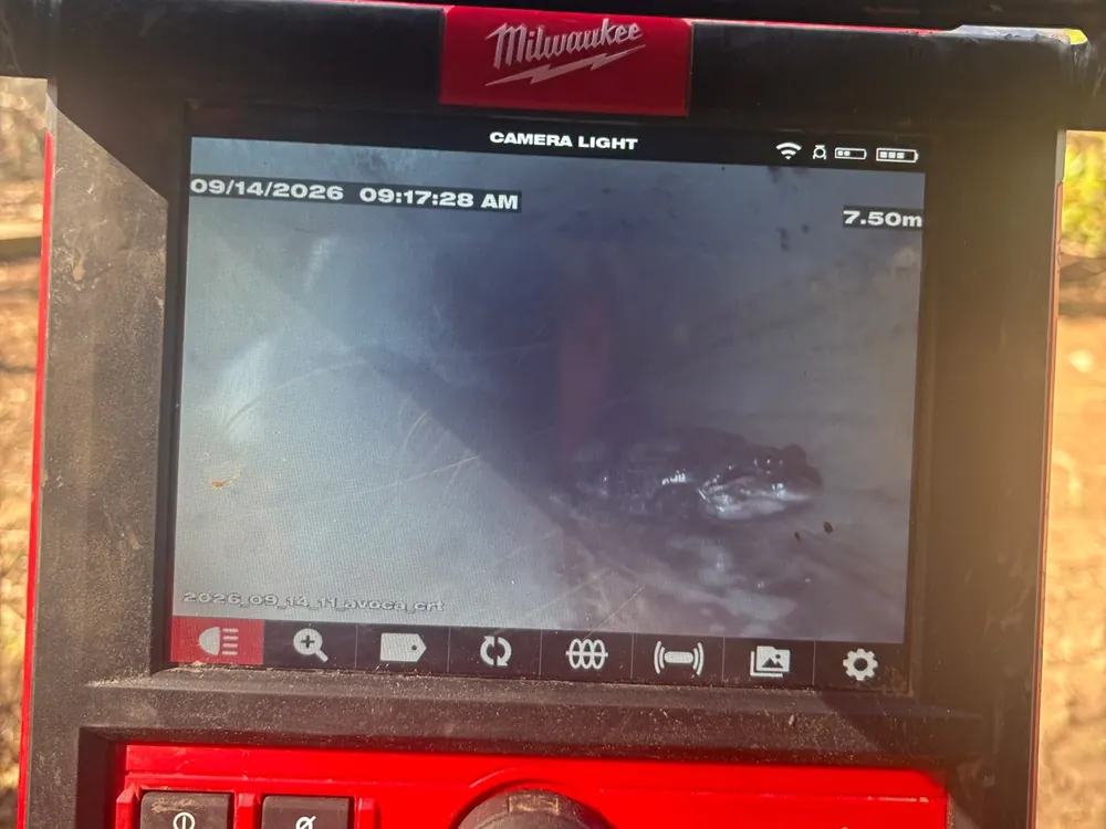 Close view of a drain camera screen showing footage from inside a pipe.
