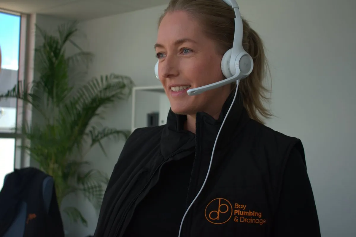 Bay Plumbing & Drainage team member answering the phone